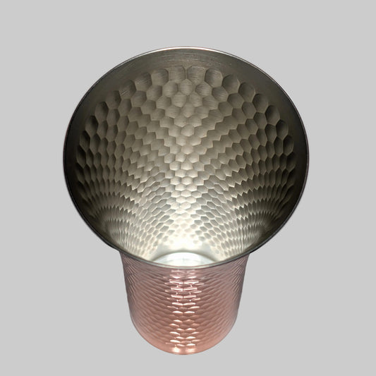 Metallic textured cup on a gray background