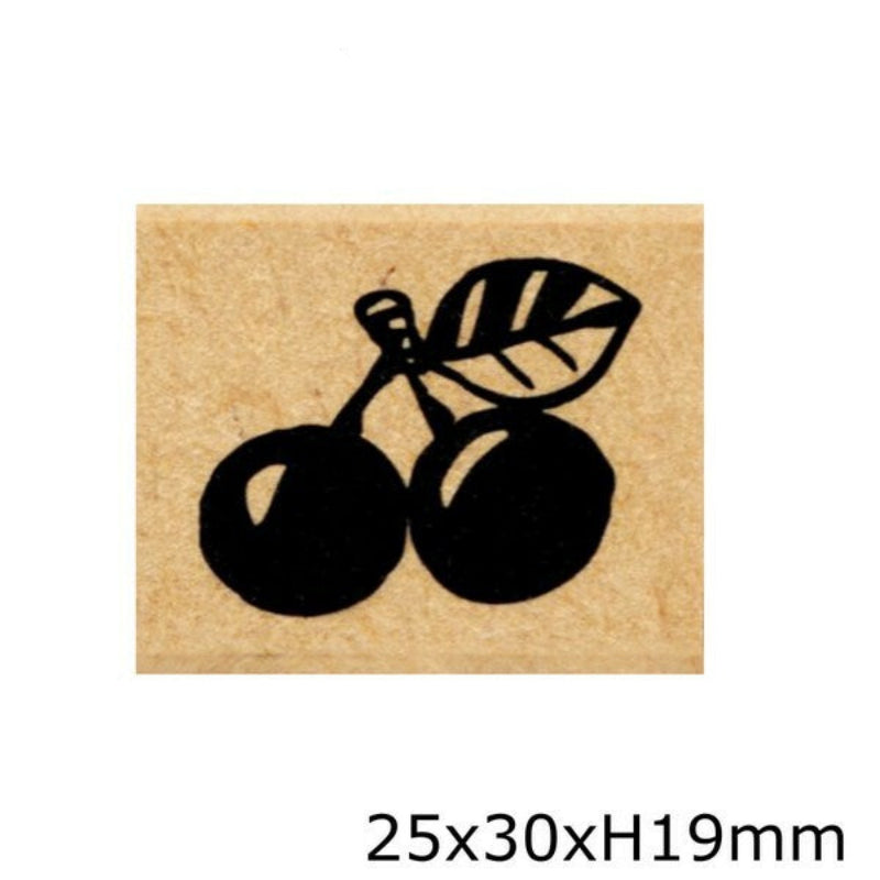 Rubber stamp with black cherry design on a beige background