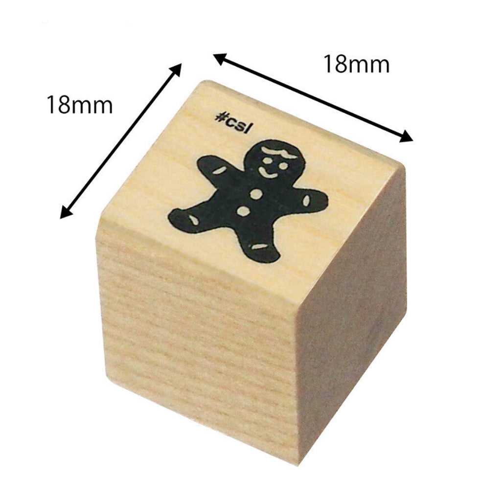 Wooden stamp with a gingerbread man design and dimensions labeled