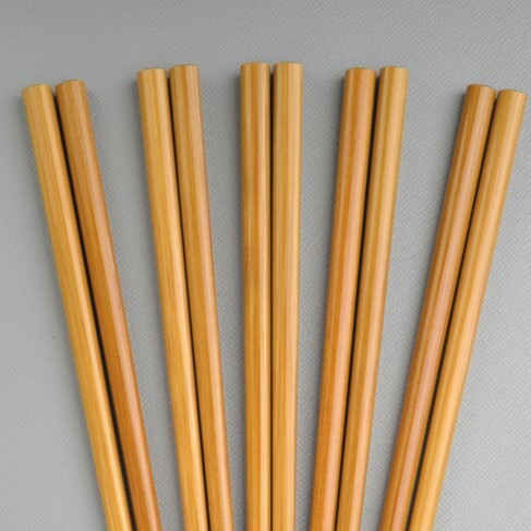 Set of wooden chopsticks on a gray background