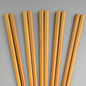 Set of wooden chopsticks on a gray background
