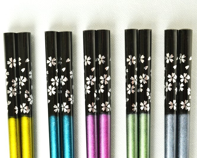 Set of black pens with white floral patterns and colorful accents on a white background