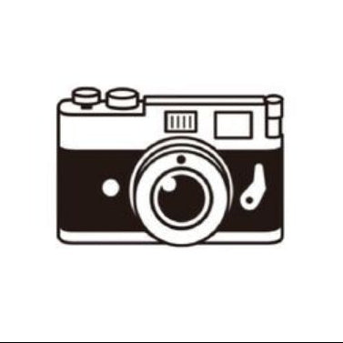 Camera-shaped rubber stamp on a white background