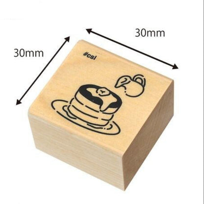 Wooden stamp block with a design of pancakes, dimensions indicated, on a white background.