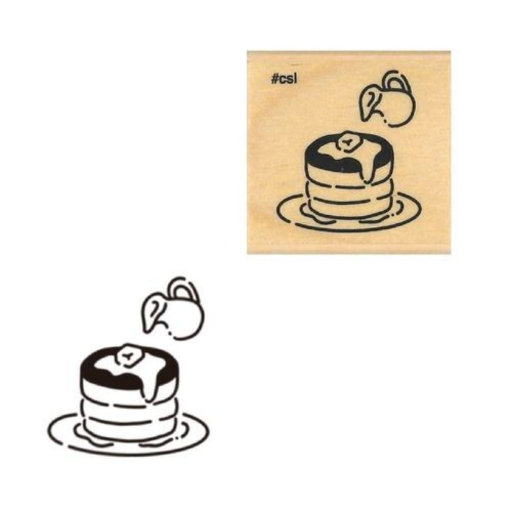 Wooden stamp with a design of a pancake and butter on top and syrup pourer.