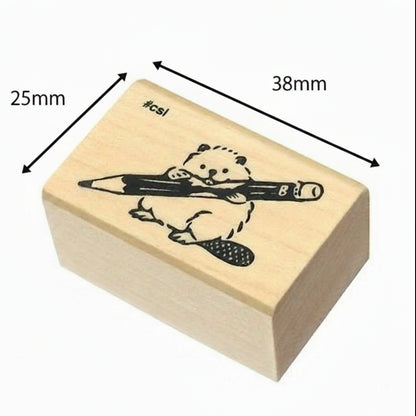 Wooden stamp with a bear holding a pencil design, showing dimensions on a white background.