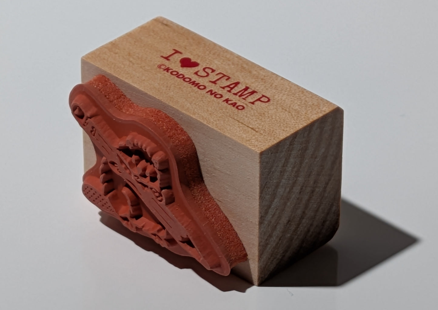 Wooden stamp with beaver chewing a pencil.