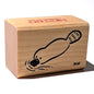 Wooden stamp block with a seal design on a white background
