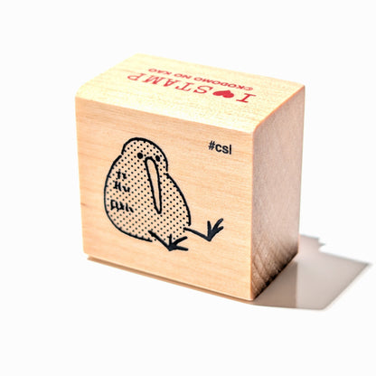 Wooden stamp block with a bird design on a white background