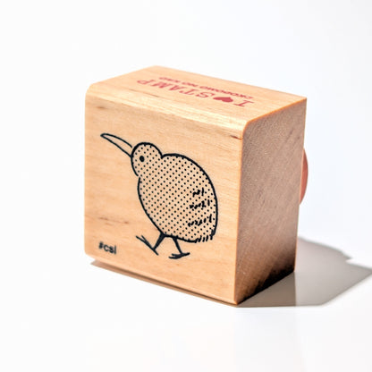 Wooden block with a kiwi bird design on a white background
