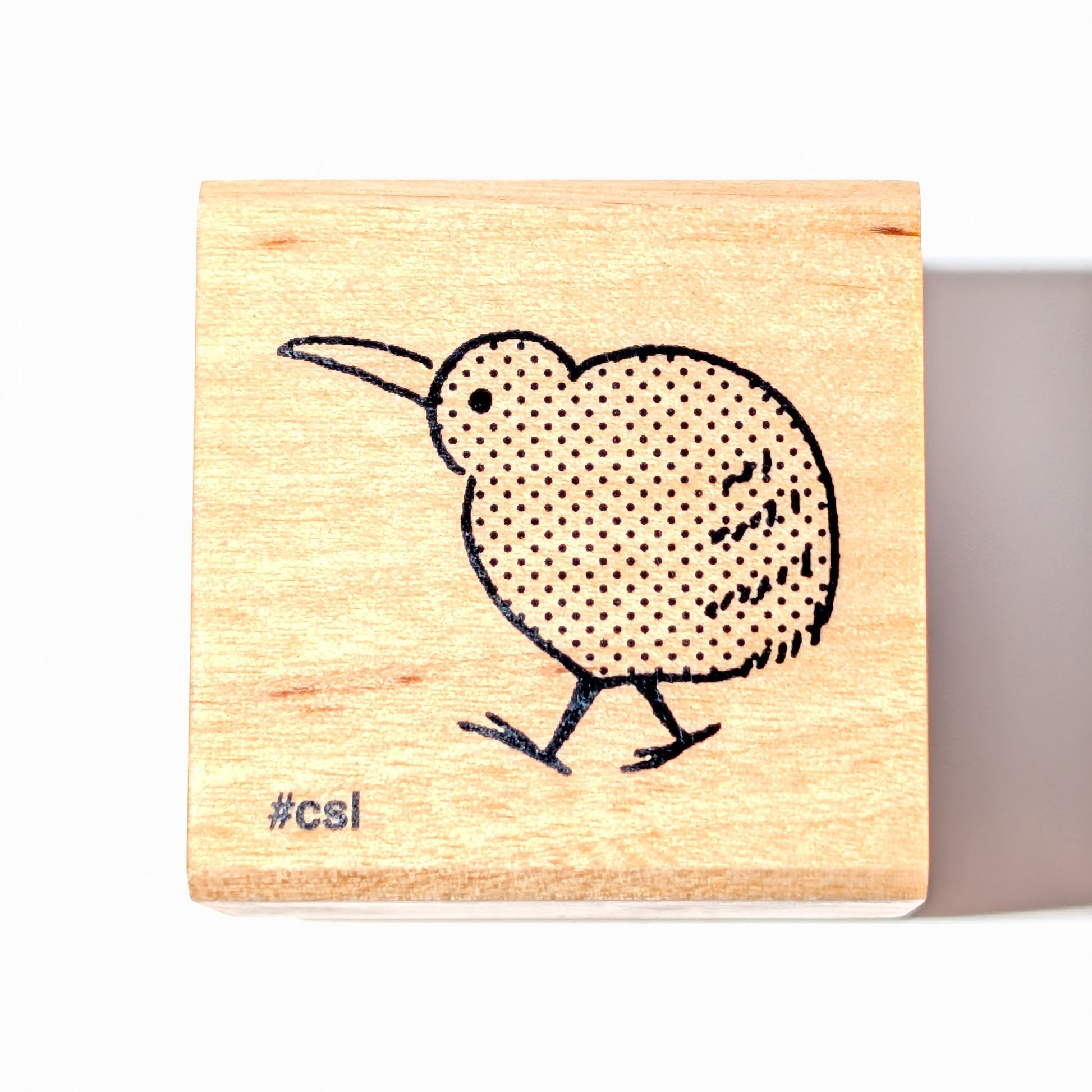 Wooden stamp with a kiwi bird design on a white background