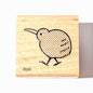 Wooden stamp with a kiwi bird design on a white background