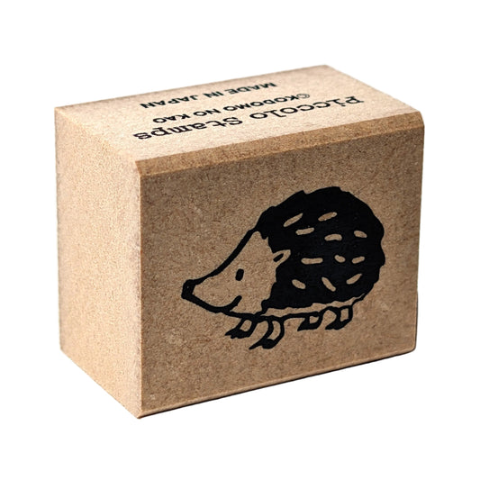 Brown cardboard block with a hedgehog design and text on a white background