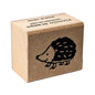 Brown cardboard block with a hedgehog design and text on a white background