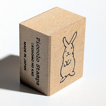 Wooden stamp block with a rabbit design and 'Piccolo Stamps' branding on a white background