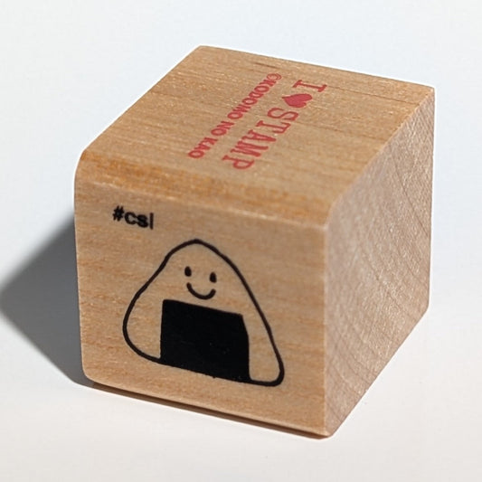 Wooden stamp with a smiley face design on a white background