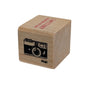 Wooden block with a camera stamp on a white background