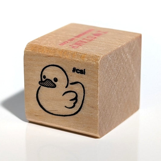 Wooden stamp with a duck design and 'cal' branding on a white background
