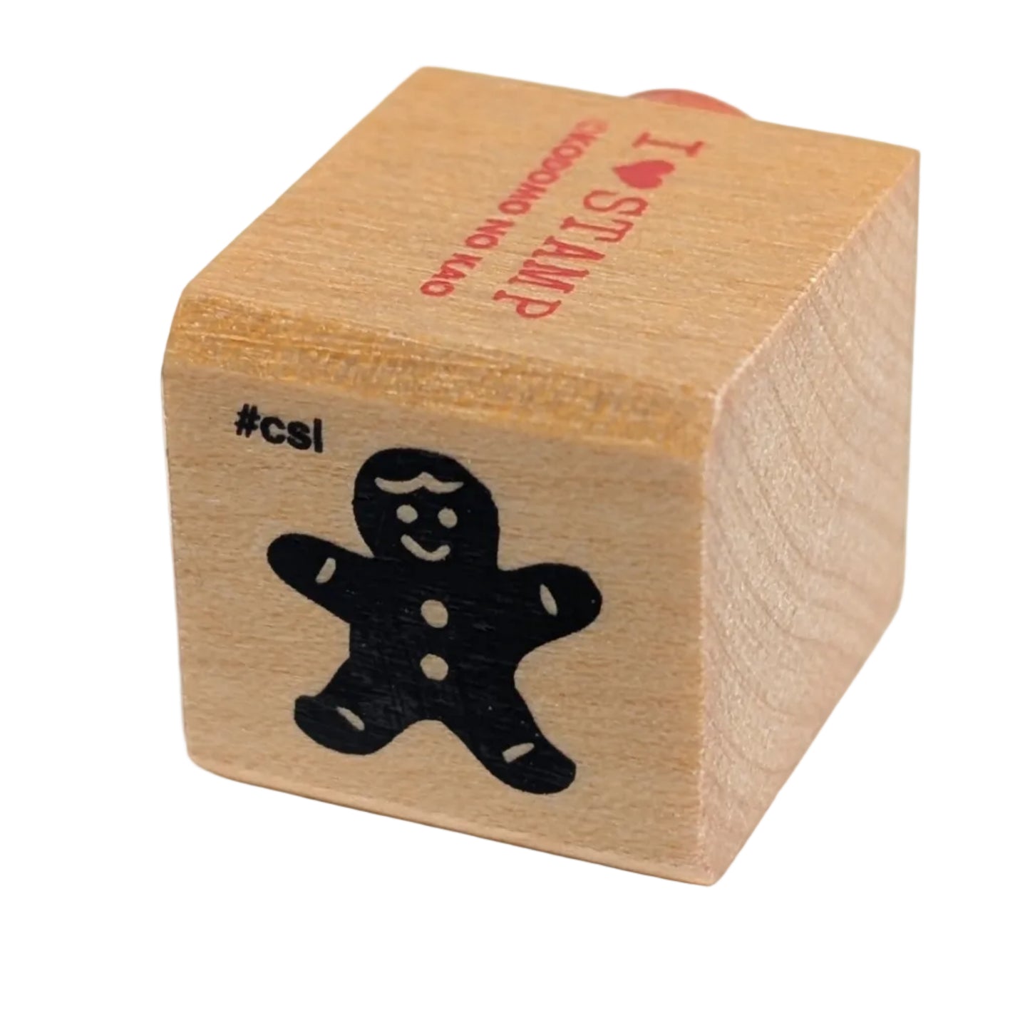 Wooden stamp with a black cutout of a gingerbread man on a white background