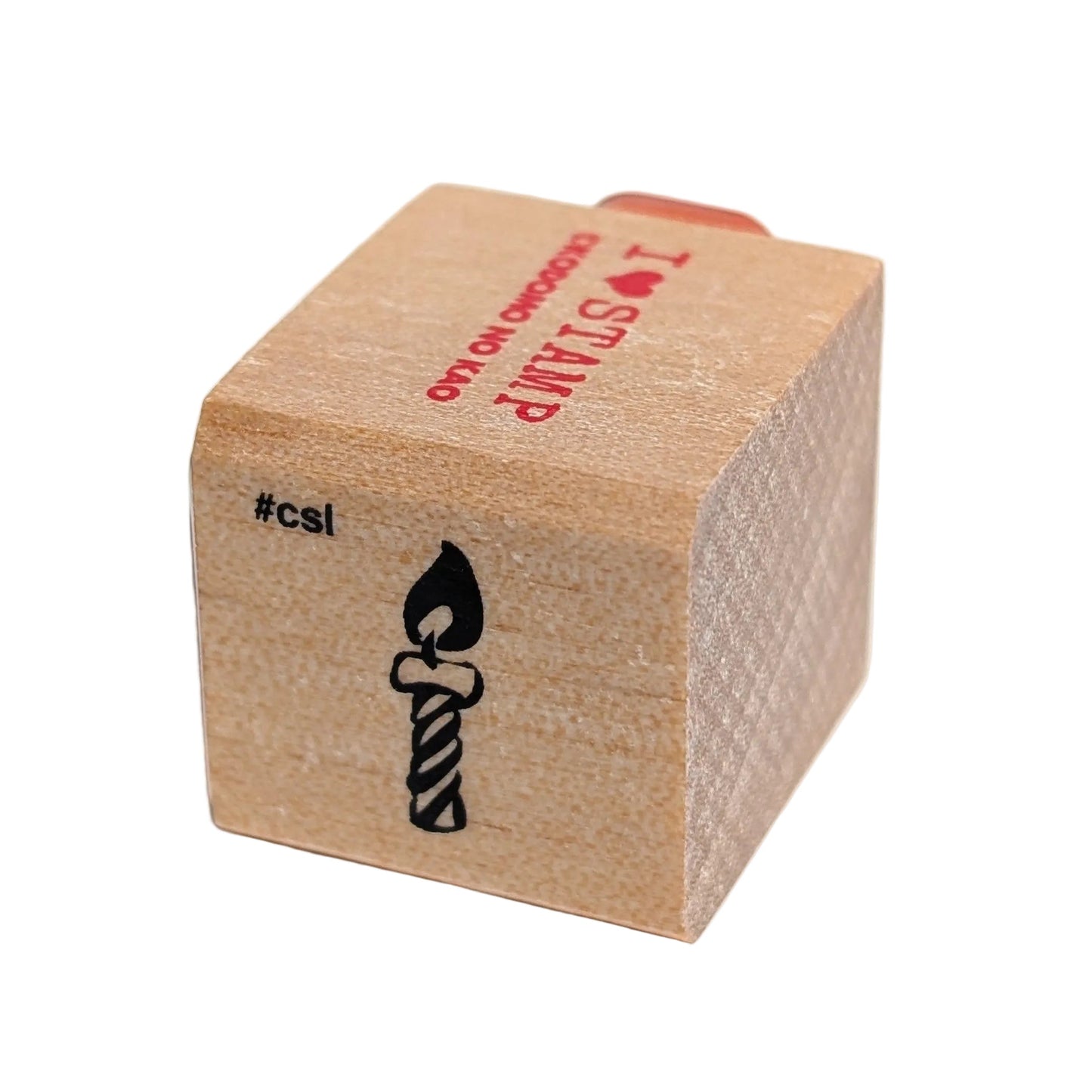 Wooden stamp block with a candle design and 'csi' branding on a white background