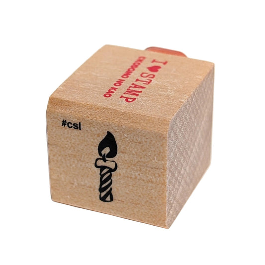 Wooden stamp block with a candle design and 'csi' branding on a white background