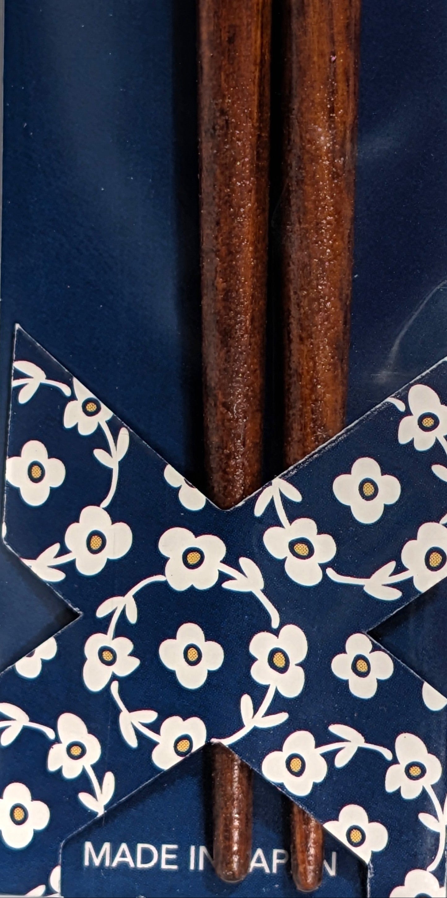 Wooden chopsticks on a blue floral-patterned box